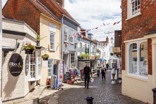 a group of people walking down a street with buildings at Sail Away in Lymington