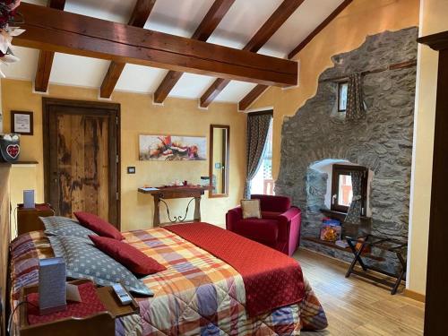 a bedroom with a large bed and a stone wall at Lo Barba in Antey-Saint-André