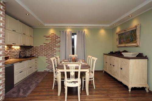 a kitchen with a table and chairs in a room at HEAVEN HOUSE in Kavala