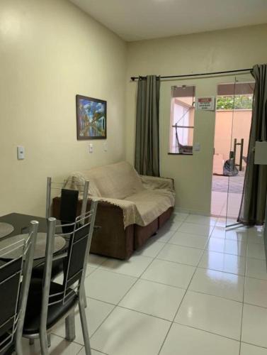 1 dormitorio con 1 cama, mesa y sillas en Lençóis Dunas Residence 1 en Santo Amaro
