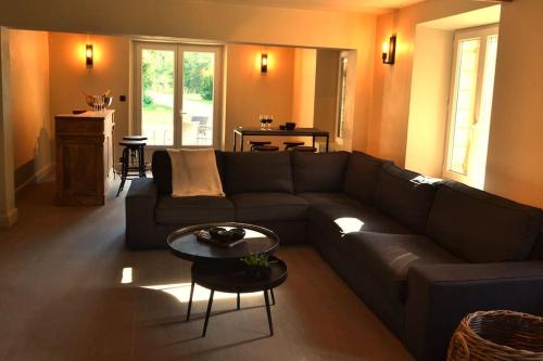 a living room with a couch and a table at Le Coin Perdu - Aubenton in Aubenton