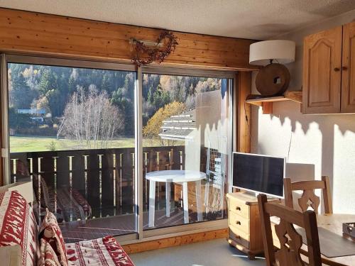 un salon avec une grande fenêtre avec vue dans l'établissement Agréable studio avec balcon proche des pistes à Chamonix, parking inclus - FR-1-517-52, à Chamonix-Mont-Blanc