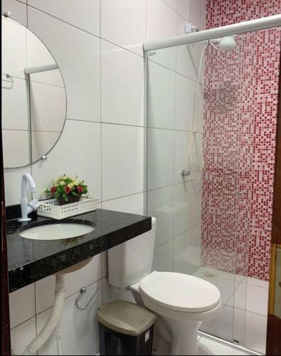 a bathroom with a toilet and a shower at Lençóis Dunas Residence 1 in Santo Amaro