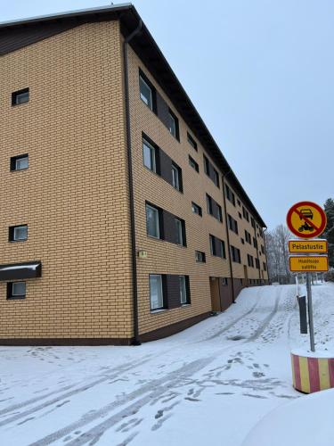 a building with a no parking sign in the snow at Wiitakoto in Viitasaari