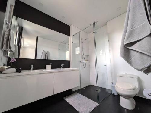 a bathroom with a toilet and a glass shower at Stylish 2 bedroom near Parque 93. FREE Parking. in Bogotá