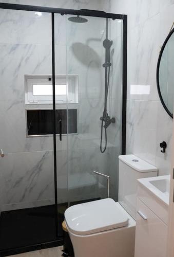 a bathroom with a shower and a toilet and a sink at Cantinho do Avô Polaco in Nazaré