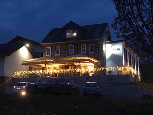 a house with cars parked in front of it at night at Ferienwohnung am Jenneberg mit KölnBonn- Ausblick in Bornheim
