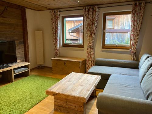 a living room with a couch and a coffee table at Öfnerhof in Leutasch