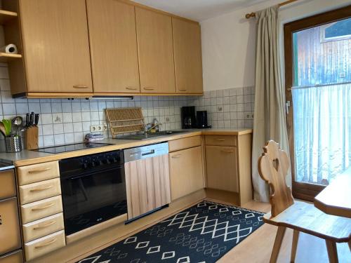 a kitchen with wooden cabinets and a stove top oven at Öfnerhof in Leutasch