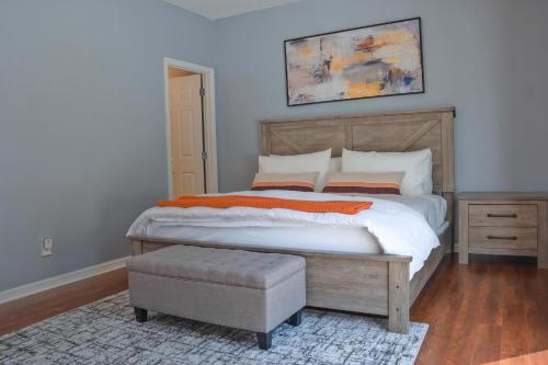 een slaapkamer met een groot bed en een poef bij TR1411RC - 3 Bedrooms - 3 Baths - Pool - Patio in Orlando