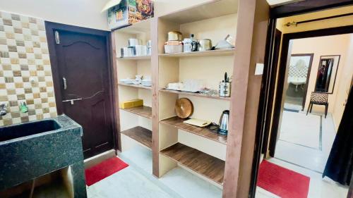 a room with a bathroom with a sink and a shelf at Prince Castle-4BHK Apartment,Guesthouse in Hyderabad