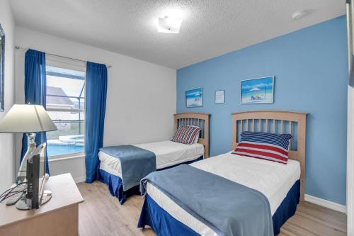a bedroom with two beds and a television in it at OT16029BH - 6 bedrooms - 12 guests in Orlando