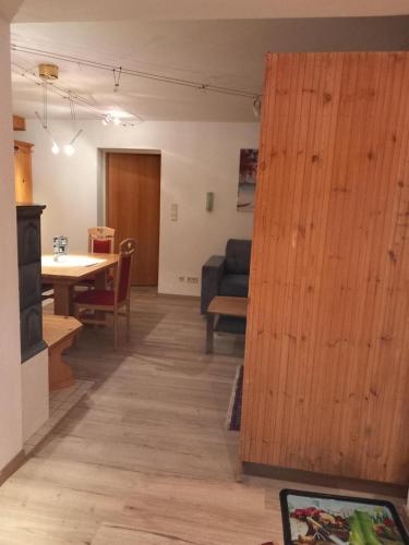 a living room and dining room with a wooden door at Landhaus-Königsberg, Vorberg 360 Ebengütlweg in Ramsau am Dachstein