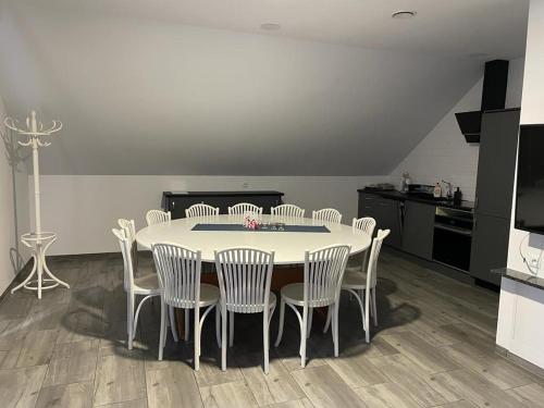 a dining room table and chairs in a kitchen at Yacht Club Apartamenty in Radzyń