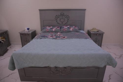 a bedroom with a large bed with two night stands at شقق ريام جيزان للعوائل in Jazan