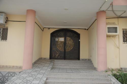 a door to a building with stairs in front at شقق ريام جيزان للعوائل in Jazan