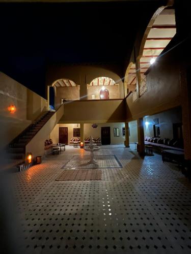 a large room with a staircase in a building at Camels House in Merzouga