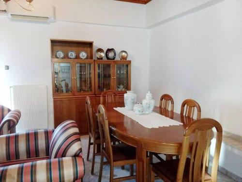 a dining room with a wooden table and chairs at TRADITIONAL HOUSE IN THE VILLAGE 