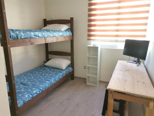 En eller flere senge i et værelse på Departament La Serena faro 2D2B