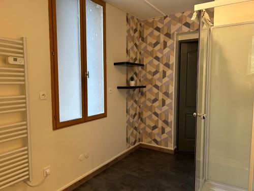 a hallway with a window and a glass door at Depagne in La Léchère