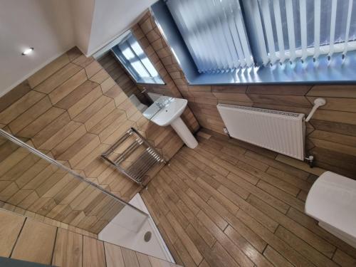 an overhead view of a bathroom with a toilet at Sussex apartments 26A in Grimsby