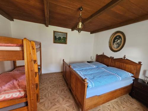 a bedroom with two bunk beds in a room at Stateček plný zvířátek 