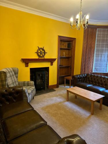 a living room with a couch and a fireplace at 4 Caberfeidh in Fort William