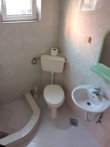 a bathroom with a toilet and a sink at Vila Sisevic in Budva
