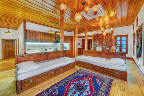 two beds in a room with wooden ceilings at The Sukabaği House in Alanya