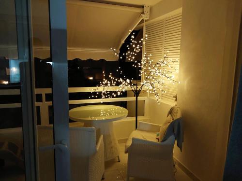 a room with a table and chairs and lights at RELAX in Playa Fañabe