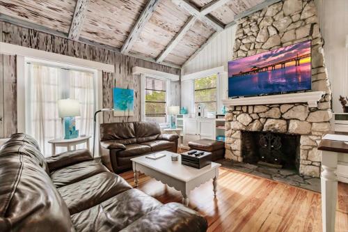 a living room with a couch and a stone fireplace at The Inn on Siesta Key in Siesta Key