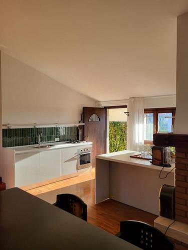 a kitchen with white cabinets and a counter top at Sentirsi a casa in Chiampo
