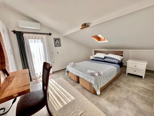 ein Schlafzimmer mit einem Bett und einem Tisch und einem Fenster in der Unterkunft Derya'ca in Kaş