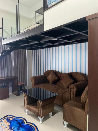 a living room with a couch and a loft at Loft apartment bintaro in South Tangerang