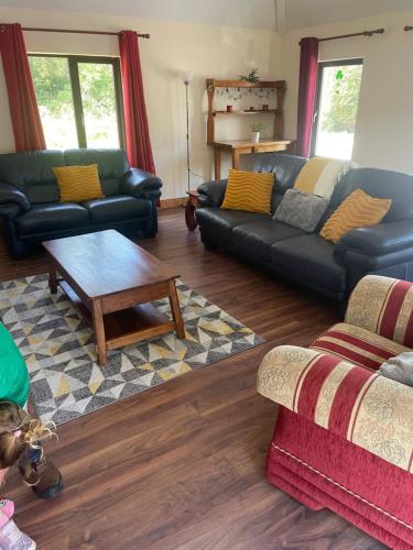 a living room with couches and a coffee table at Castlegregory-Seaside 2 Bedroomed Cottage in Castlegregory