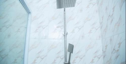 a shower stall with a light in a bathroom at Extended Stay Suite, Tema. in Tema