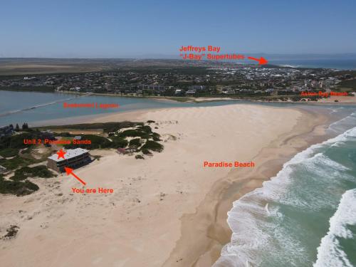 an aerial view of a beach with a house and the ocean at Paradise Beachfront Apartment in Jeffreys Bay