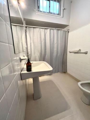 a bathroom with a sink and a toilet at C&M in Mar del Plata