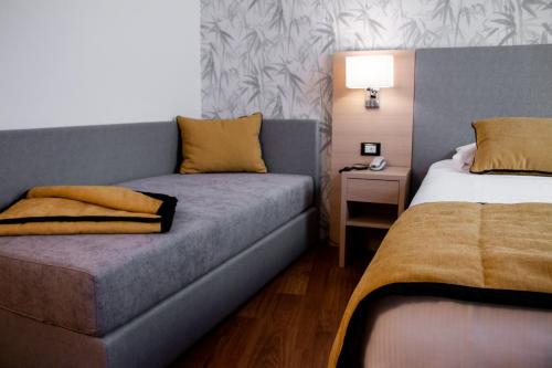 a hotel room with a couch and a bed at Hotel Accademia in Bologna