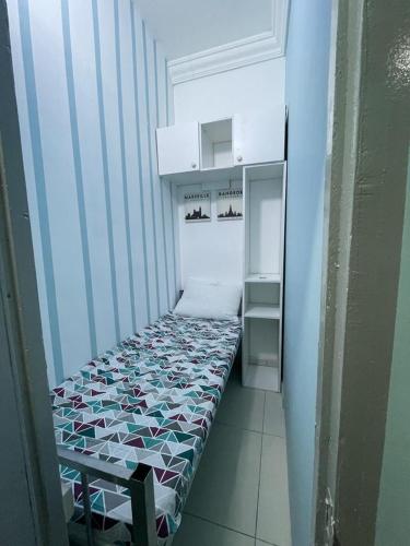 a small room with a bed and a refrigerator at Partations For Rent in Dubai