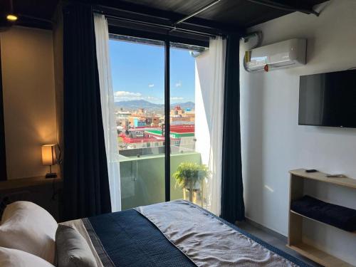 Postel nebo postele na pokoji v ubytování Hotel Ciclovía & Terraza