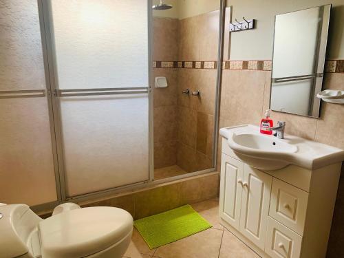 a bathroom with a shower and a toilet and a sink at Peruvian House - Miraflores in Lima