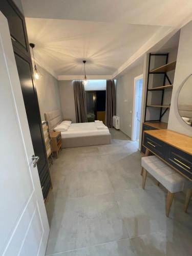 a bedroom with a bed and a mirror in a room at Luxury Rooftop Vlora in Vlorë