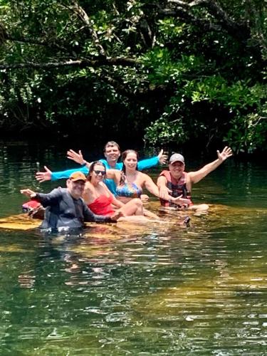 a group of people on a raft in the water at Pousada Filhos da Canastra in Vargem Bonita
