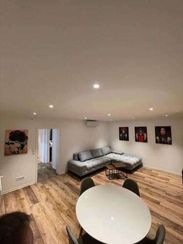 a living room with a couch and a table at Penthouse, Offenburg,Europapark in Offenburg