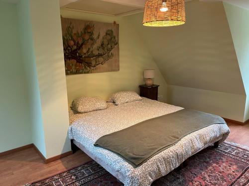 ラ・プティット・ピエールにあるLe cordonnier du Staedelのベッドルーム1室(ベッド1台付)が備わります。壁には絵画が飾られています。