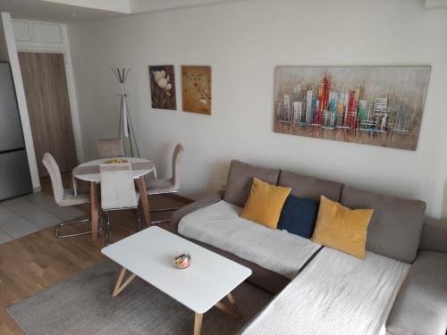 a living room with a couch and a table at Belgrade Waterfront Comfortable Apartment in Belgrade