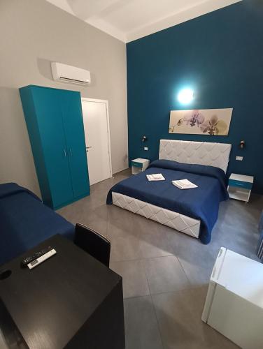 a room with a bed and a table in it at Oasi del Turista in Palermo