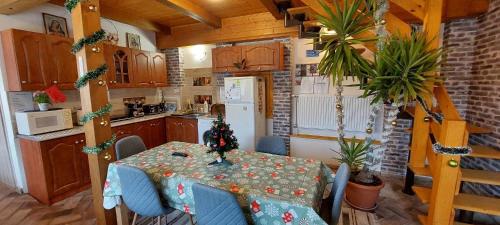 a kitchen with a dining room table with a christmas table at Teodor Apartman in Gyula