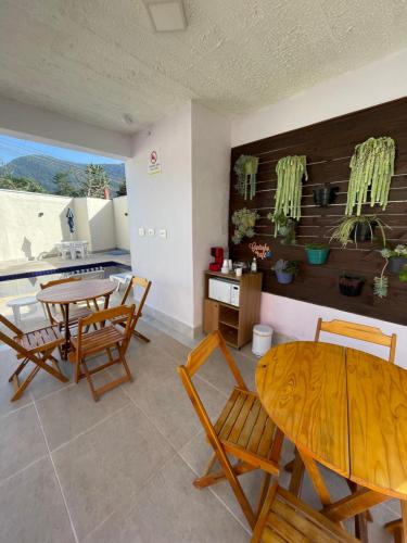 a kitchen and dining room with a table and chairs at Residencial 220 Maresias in Maresias